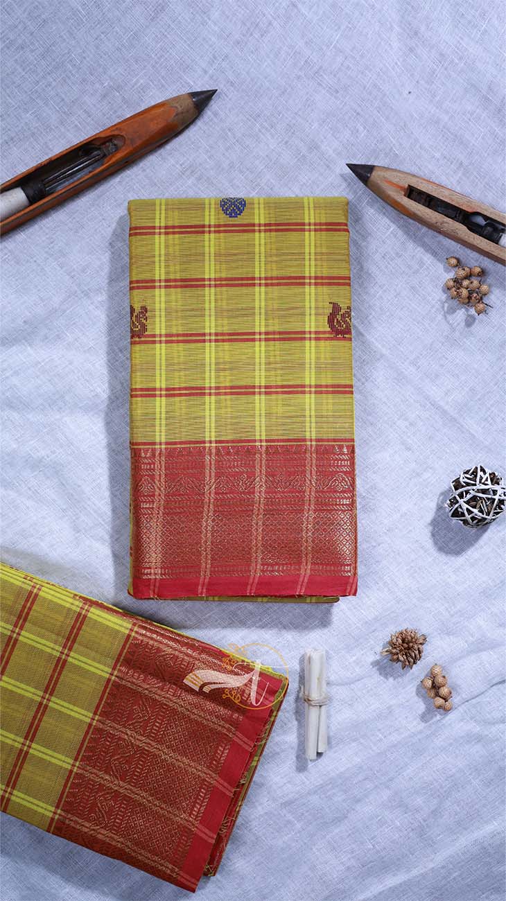 Two patterned books on a textured surface with writing instruments and decorative items.