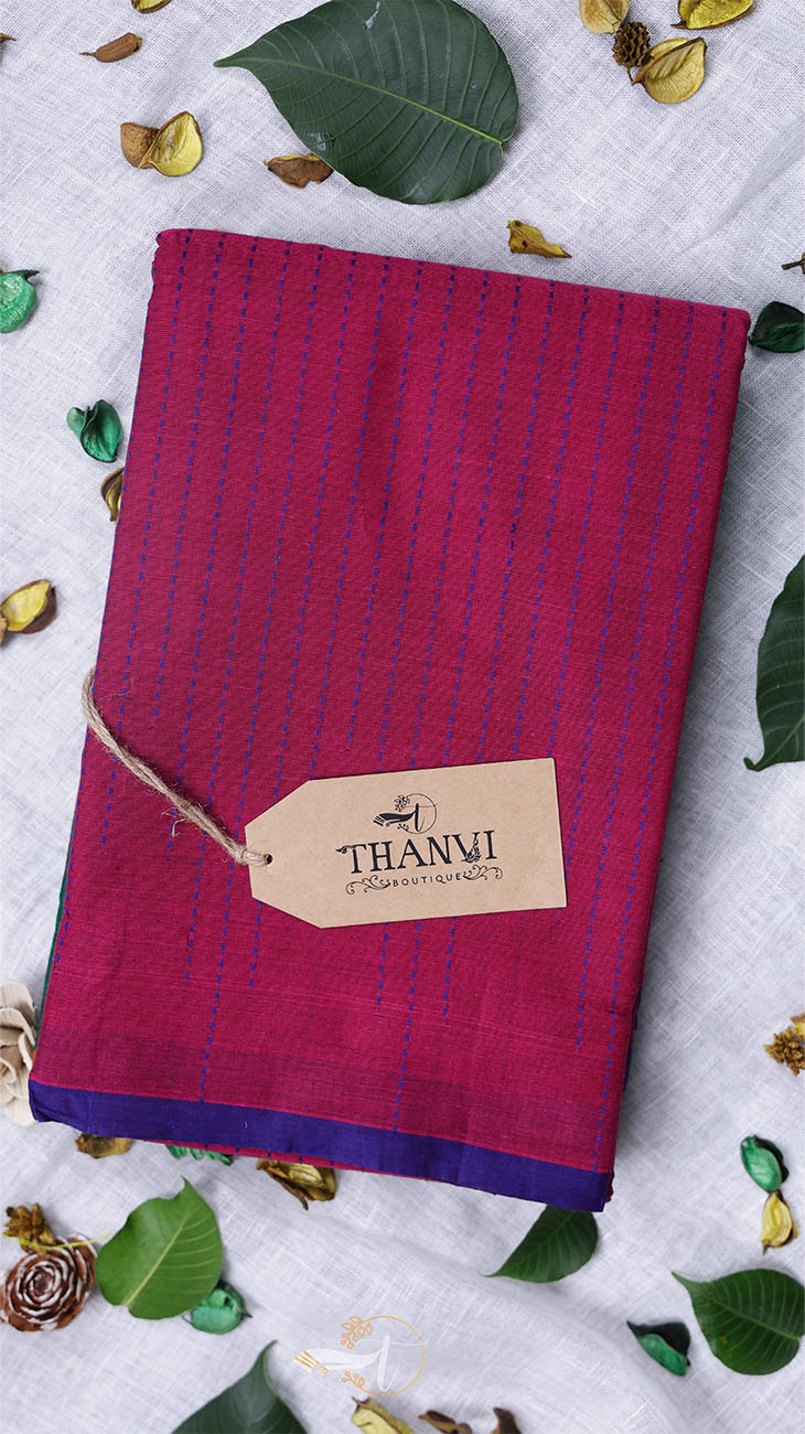 Folded fabric with a 'THANVI' tag on a white background with green leaves.