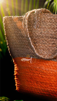 Close-up of a woven basket with a textured surface, featuring a brand logo in the corner.