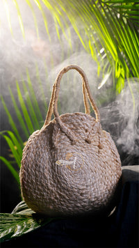 Woven handbag with a textured surface against a natural background