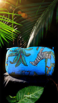 Blue pouch with animal pattern on a leafy background