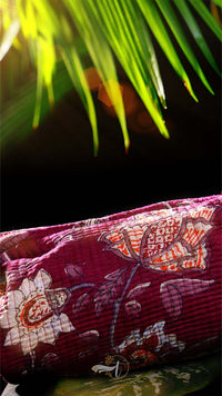 Decorative pillow with floral patterns on a dark background
