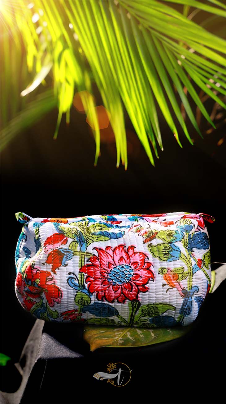 Floral-patterned pouch with a palm leaf in the background