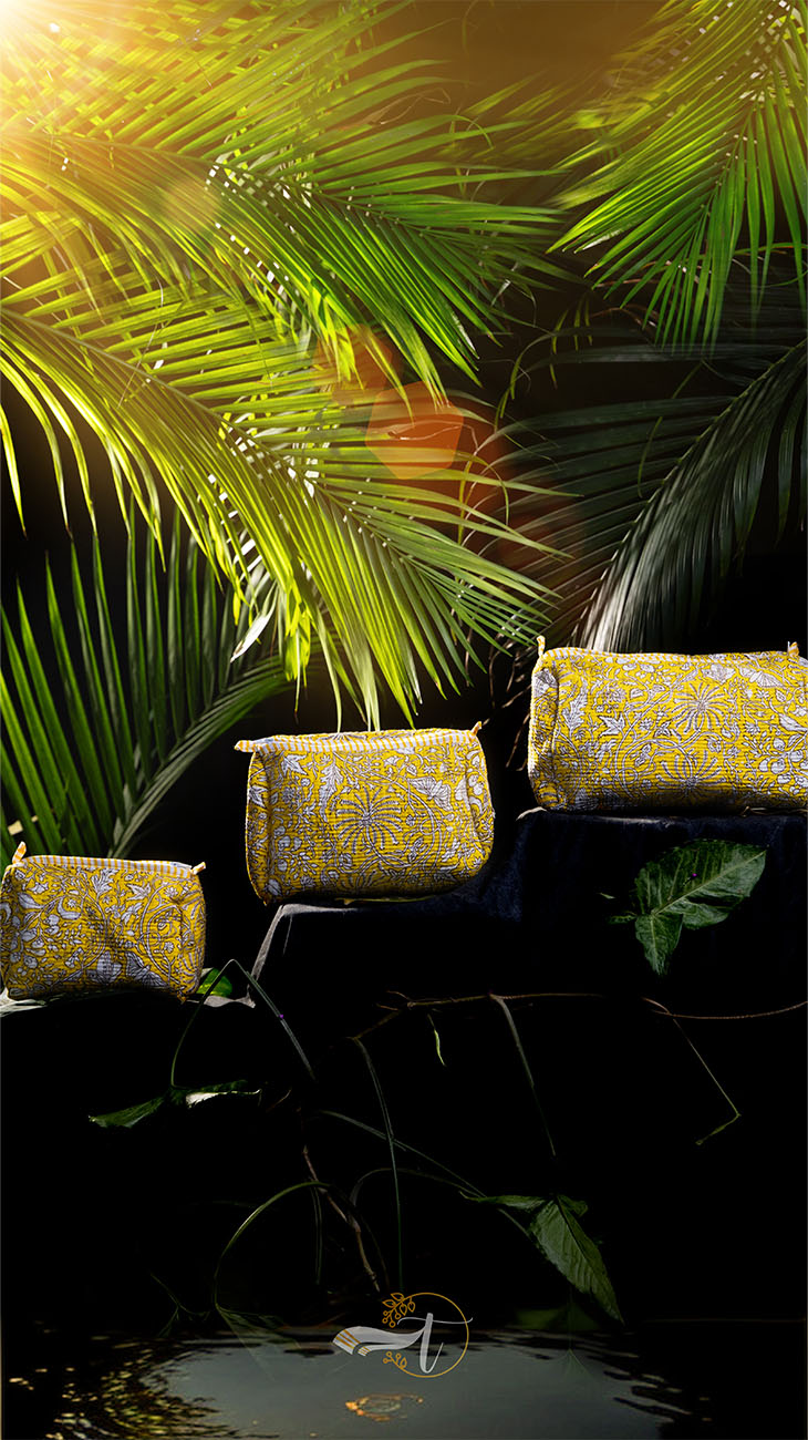 Decorative yellow pots with patterns on a dark background with green foliage