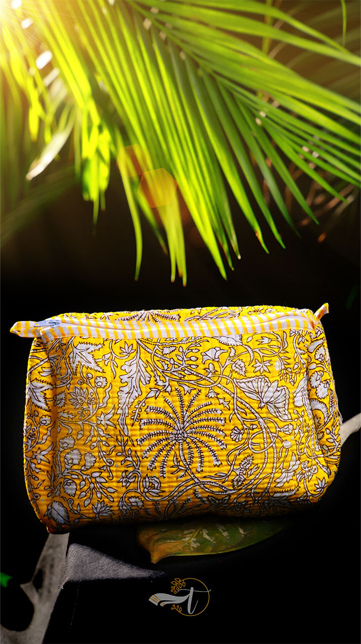 Yellow patterned bag with palm leaves in the background