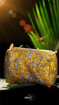 Yellow patterned pouch with a plant in the background