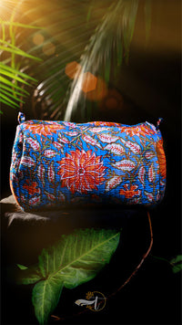 Colorful floral-patterned pouch on a dark background with green leaves.