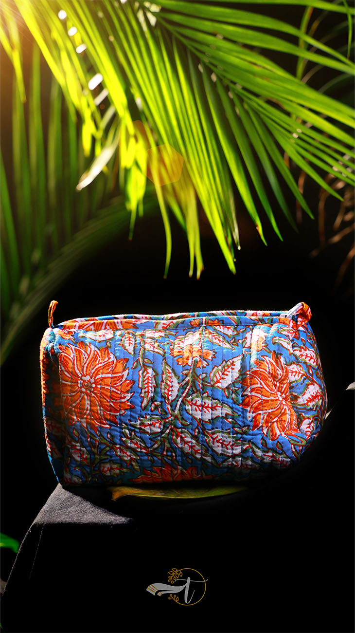 Colorful floral-patterned bag with a palm leaf in the background