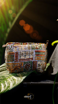 Colorful patchwork bag on a leaf with a blurred background