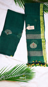 Green traditional fabric with embroidery and a tag on a white background with green leaves.