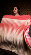 Woman holding a large piece of fabric with a gradient design against a dark background