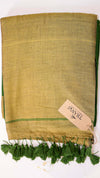 Green fabric with tassels and a brand tag on a white background