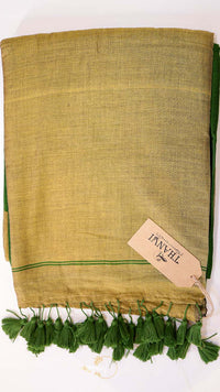 Green fabric with tassels and a brand tag on a white background