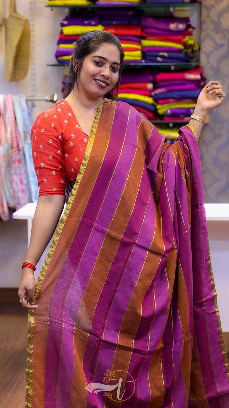 Woman wearing a red and purple saree with a colorful background