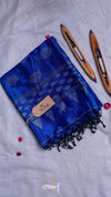 Blue scarf with black patterns and tassels on a light gray background