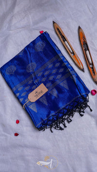 Blue scarf with black patterns and tassels on a light gray background
