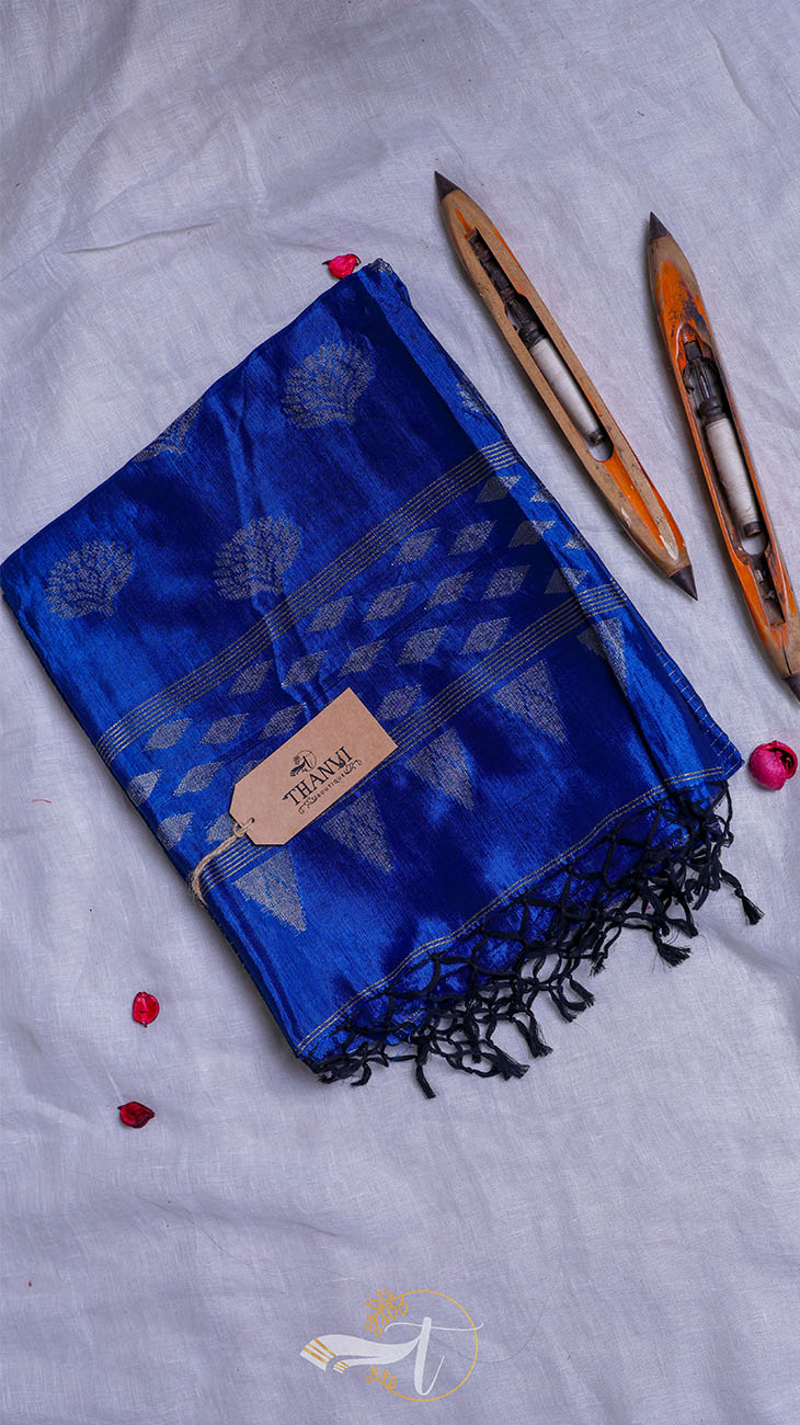 Blue scarf with black patterns and tassels on a light gray background