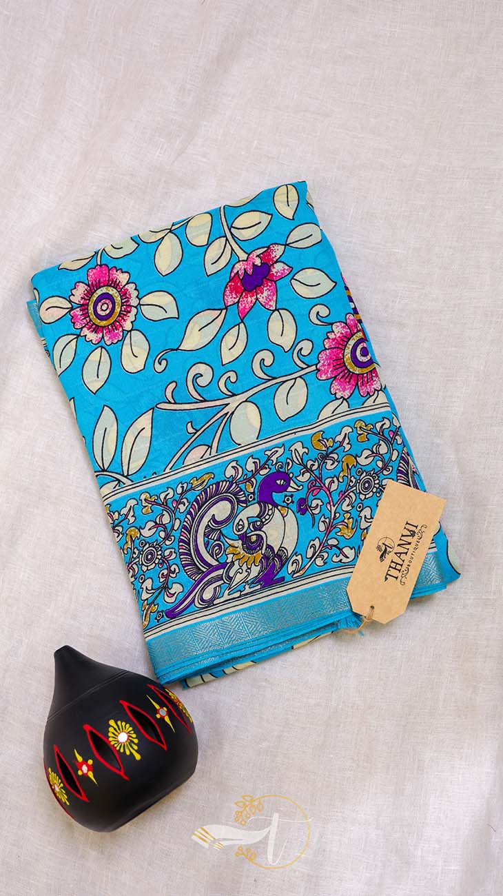 Colorful fabric with floral patterns and a black decorative item on a light background