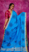Woman wearing a blue saree with a pink background