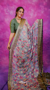 Woman wearing a floral saree with a purple background