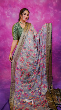 Woman wearing a floral saree with a purple background