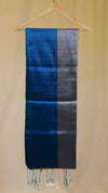 Blue and gray striped scarf on a wooden hanger against a beige background