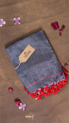 Denim fabric with red fringes on a brown background with flowers