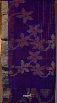 Purple fabric with floral patterns and a logo in the corner