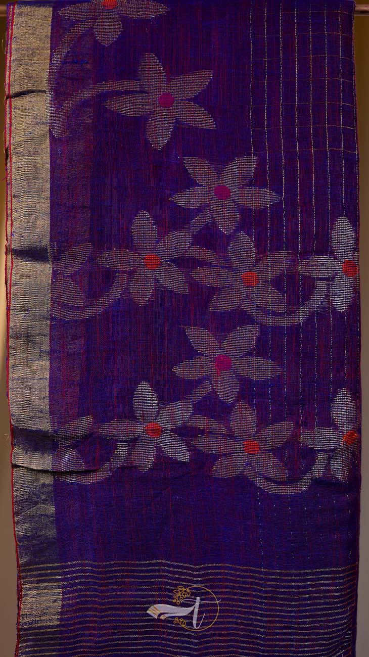 Purple fabric with floral patterns and a logo in the corner