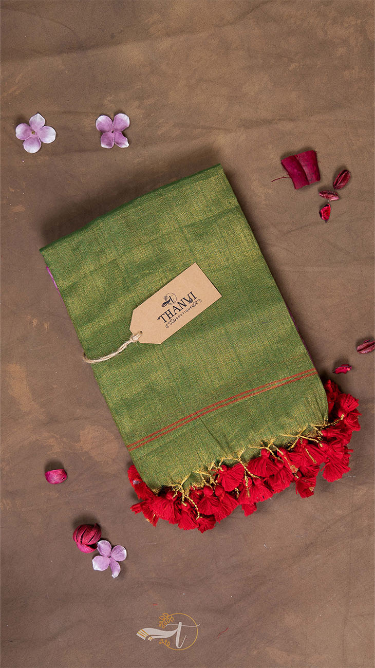 Green fabric with red floral elements and a 'THAMJU' tag on a brown background