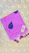 Pink towel with floral design and tag on a floral background