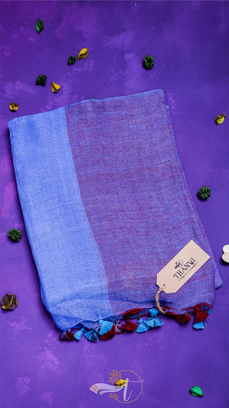 Blue and purple fabric with tassels on a purple background