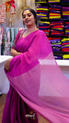 Woman wearing a pink saree in a fabric store