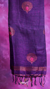 Purple scarf with pink floral patterns and black tassels on a pink background