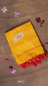 Yellow saree with red and pink flower petals on a brown background