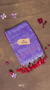 Purple scarf with red tassels on a brown background