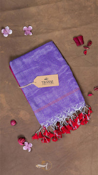 Purple scarf with red tassels on a brown background