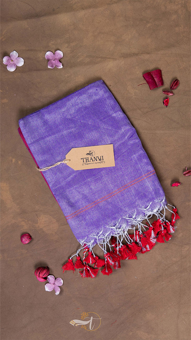 Purple scarf with red tassels on a brown background