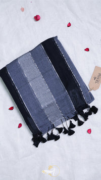 Striped towel with tassels on a light gray background