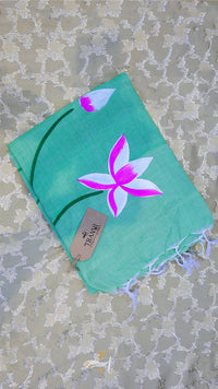 Turquoise scarf with pink flower design on a textured surface