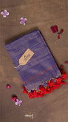 Blue fabric with red tassels on a brown background