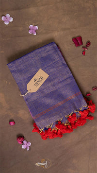 Blue fabric with red tassels on a brown background