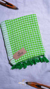 Green checkered towel with tassels on a white background