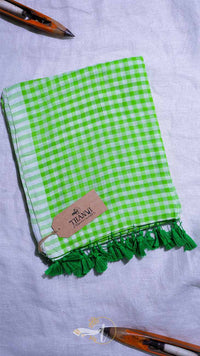 Green checkered towel with tassels on a white background