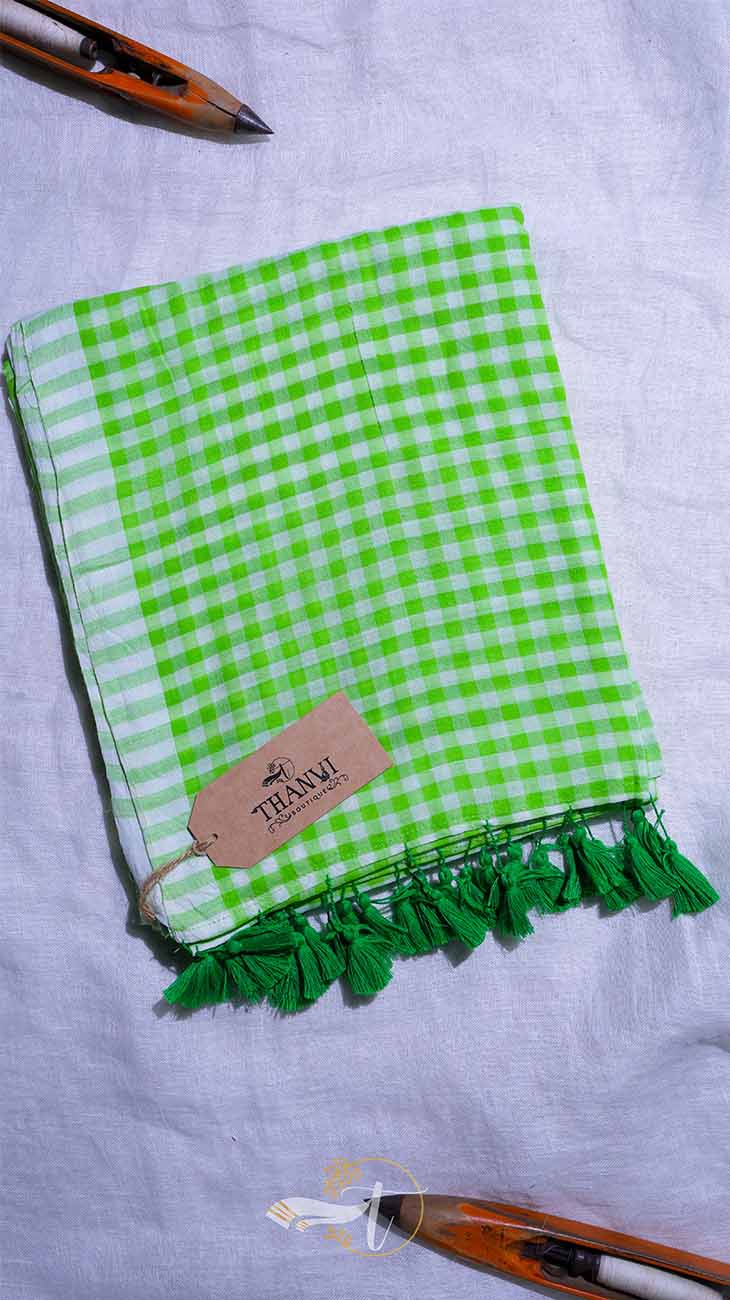 Green checkered towel with tassels on a white background