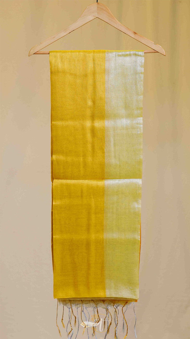 Yellow and green striped fabric on a hanger against a beige background