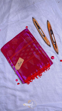 Red fabric pouch with tassels and a tag on a light gray background