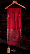 Red scarf with embroidery on a hanger against a blurred background