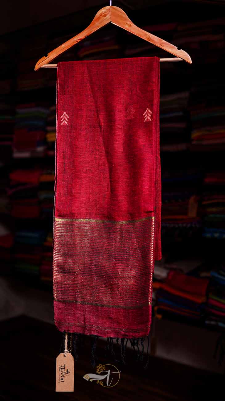 Red scarf with embroidery on a hanger against a blurred background