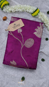 Purple fabric with floral patterns on a gray surface with decorative elements
